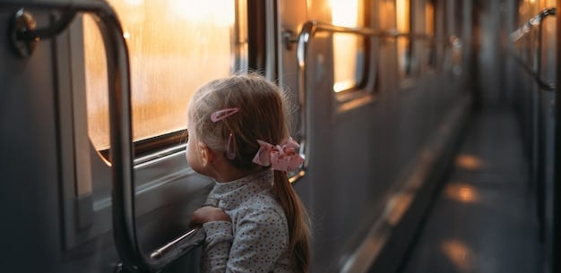 Premium Photo | Girl child looking though train window on sunset