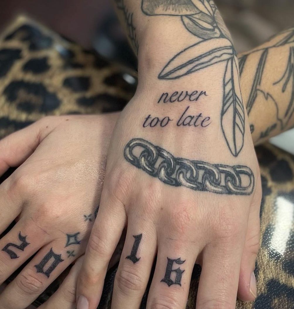 Tattooed hands that read, "never too late"