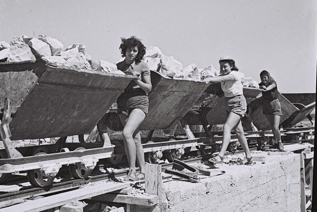 Image of women pioneers carting rocks from the quarry in pre-State Israel