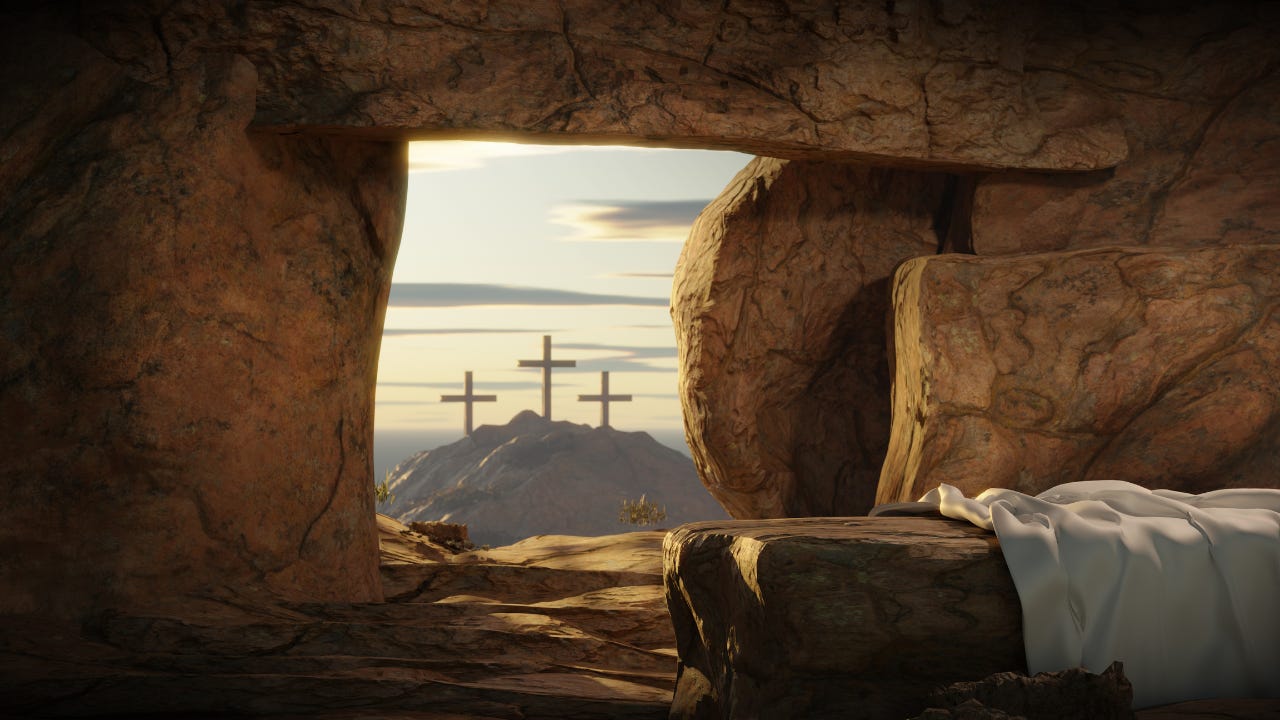 The empty tomb of Jesus looking out at three crosses.