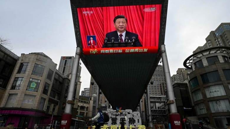 Xi Jinping, shown on an outdoor screen delivering a speech during the National People’s Congress