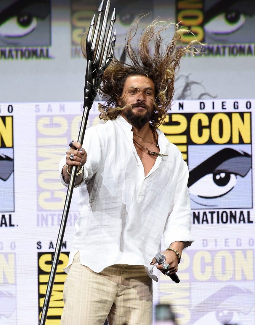 jason momoa works his trident at comic con 2018