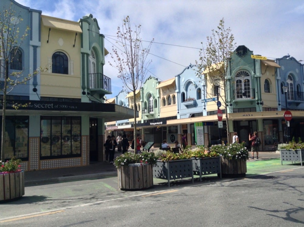 Pastel-coloured buildings form a pretty shopping street