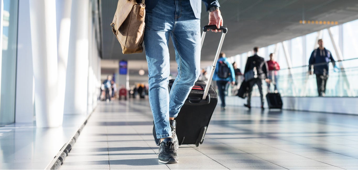 Photos: Representative image: Man walking in airport terminal - Outlook ...