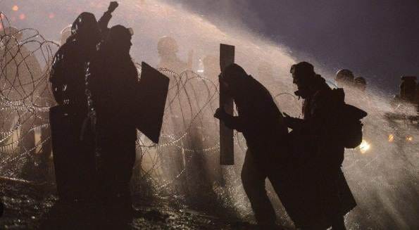 BBC news pic of water cannon spraying people BBC news pic of water cannon spraying people