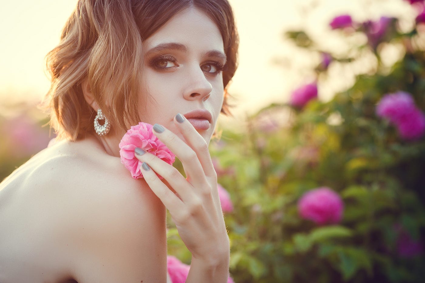 Topless woman with rose on her shoulder