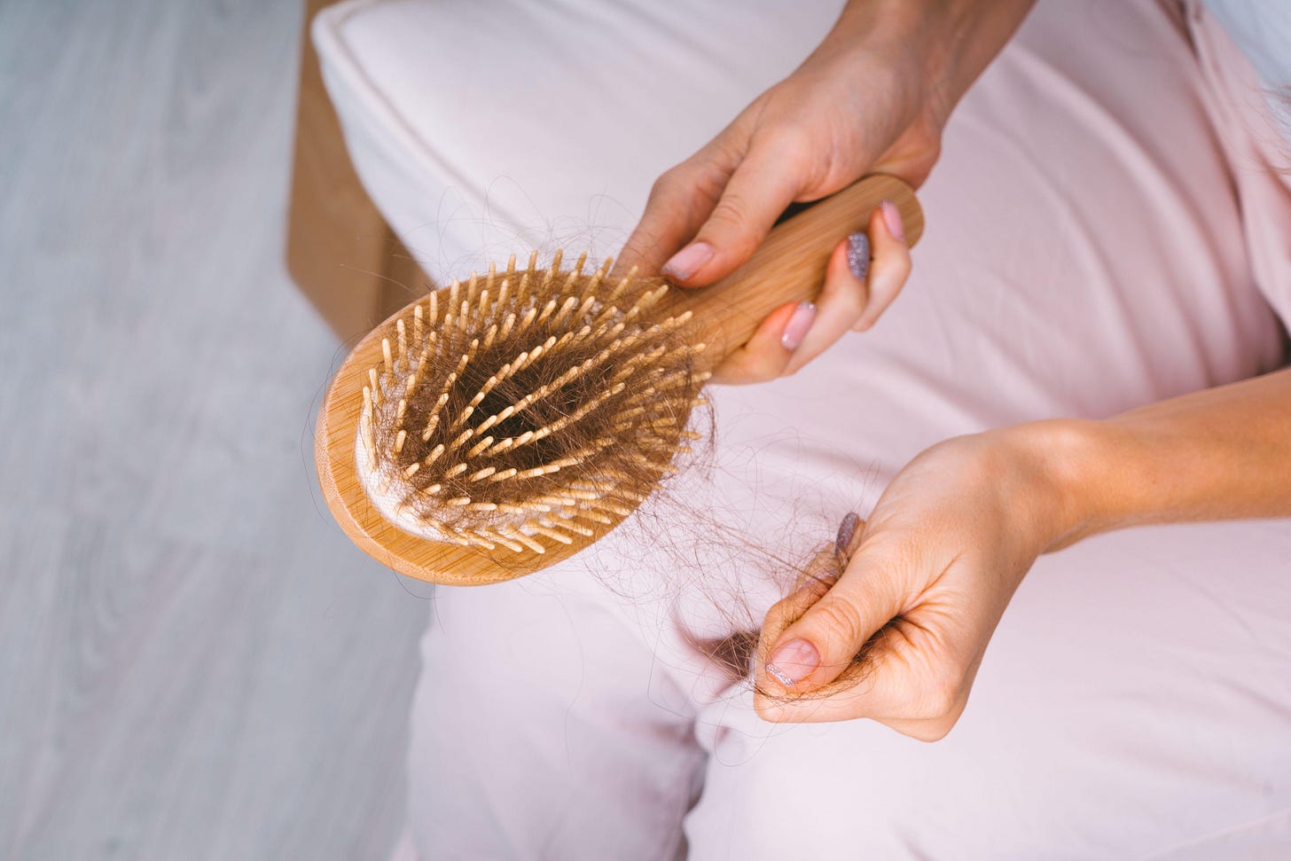 Woman taking her hair from hairbrush