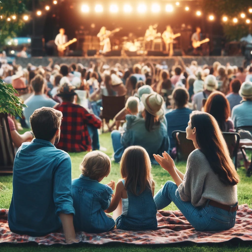 A scene of a family attending an outdoor music concert together. The family, consisting of two parents and their children, is sitting on a grassy area with a picnic blanket spread out beneath them. They are surrounded by other concert-goers in a park-like setting, with a stage visible in the background where a band is performing. The family is attentively listening to the music, with expressions of enjoyment and relaxation on their faces. The children are sitting between the parents, one of them clapping along to the music. The atmosphere is festive and communal, with string lights visible as the evening sets in, adding to the ambiance of the outdoor concert. This image captures the joy of shared musical experiences, enhancing the bond within the family.
