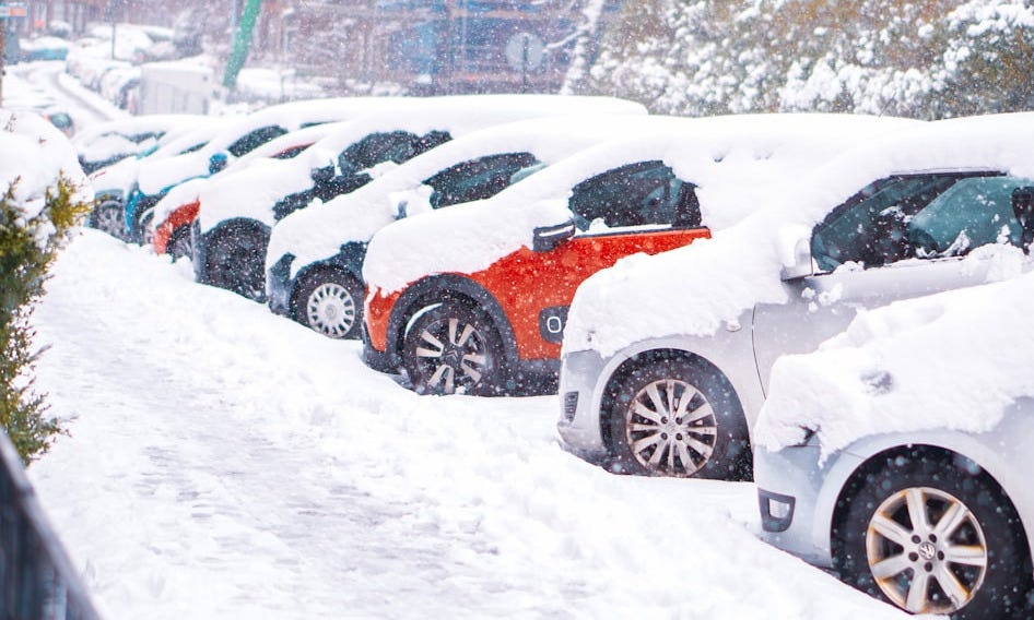 black suv covered with snow