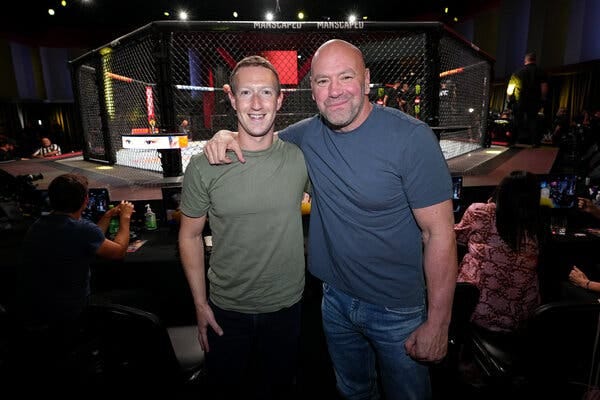 Dana White, president of the Ultimate Fighting Championship, standing with one arm around the shoulder of Mark Zuckerberg, Meta’s chief executive. A U.F.C. cage is behind them.