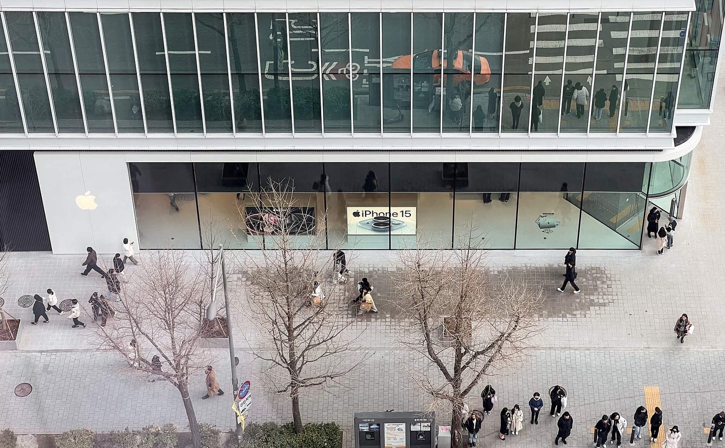 The exterior of Apple Hongdae and adjacent walkway, shot from a high vantage point.