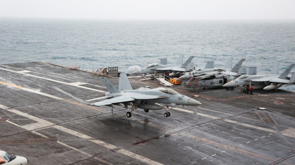 F/A-18E Super Hornet landing on aircraft carrier.