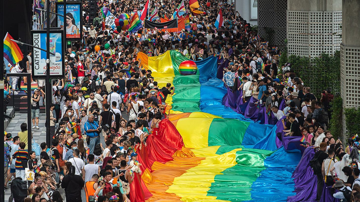 Participants march on Sukhumvit road while holding a rainbow flag during the Bangkok Pride Parade 2024, in Bangkok, Thailand on June 1, 2024.