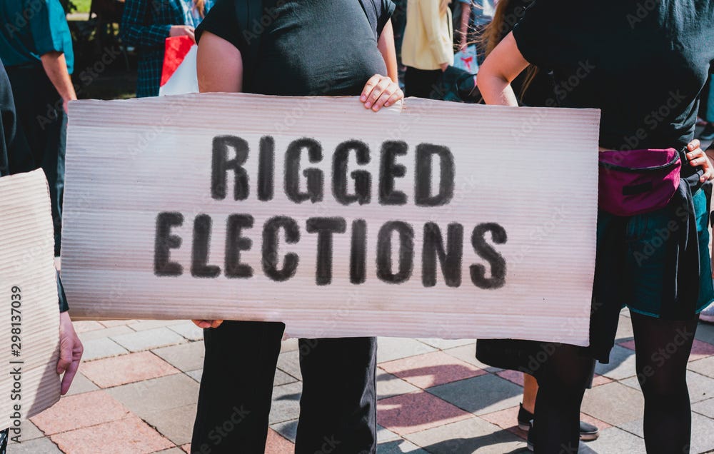 The phrase " Rigged Elections " drawn on a carton banner in hand. A girl  holds a cardboard with an inscription. Girls on the street. Protest.  Election. Vote. Stolen Stock Photo | Adobe Stock