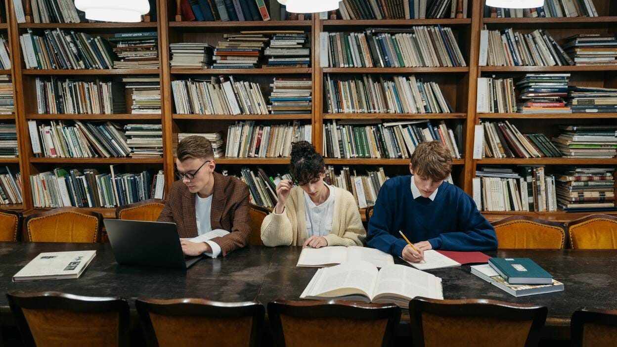 Students in library with papers