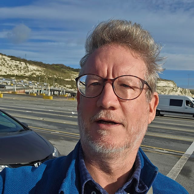 Photo of me at the ferry terminal with the white cliffs behind me