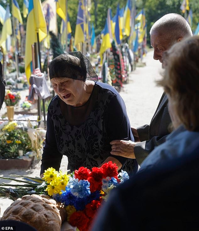 Parents of late Ukrainian rescue unit member Ruslan Koshovyi attend his funeral in Kyiv