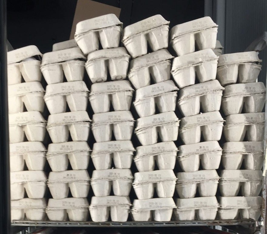 a bunch of white cups stacked on top of each other