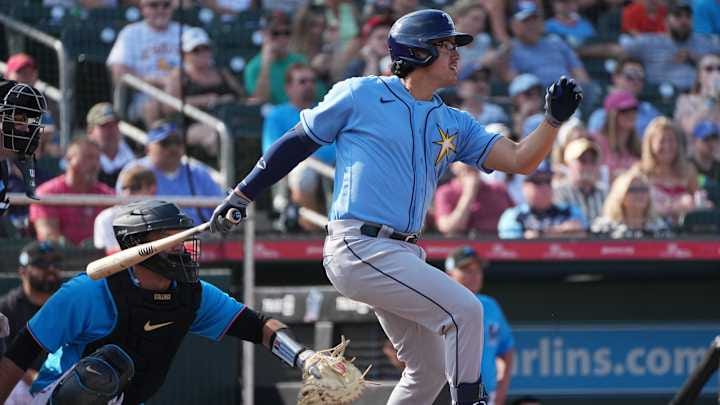 Tampa Bay Rays third baseman Austin Shenton (93) hits a double against the Miami Marlins in the third inning at Roger Dean Stadium in 2023.