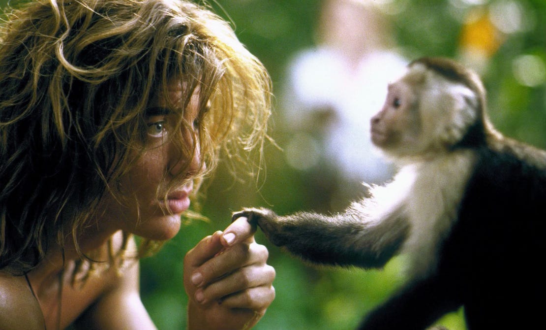 Still from George of the jungle holding hands with a spider monkey