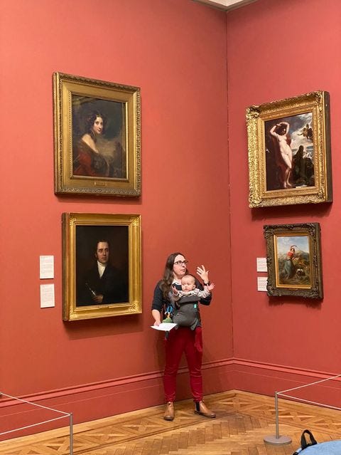 Me reading at the Manchester Art Gallery in front of William Etty's Andromeda & Perseus with my daughter in a baby carrier on my chest
