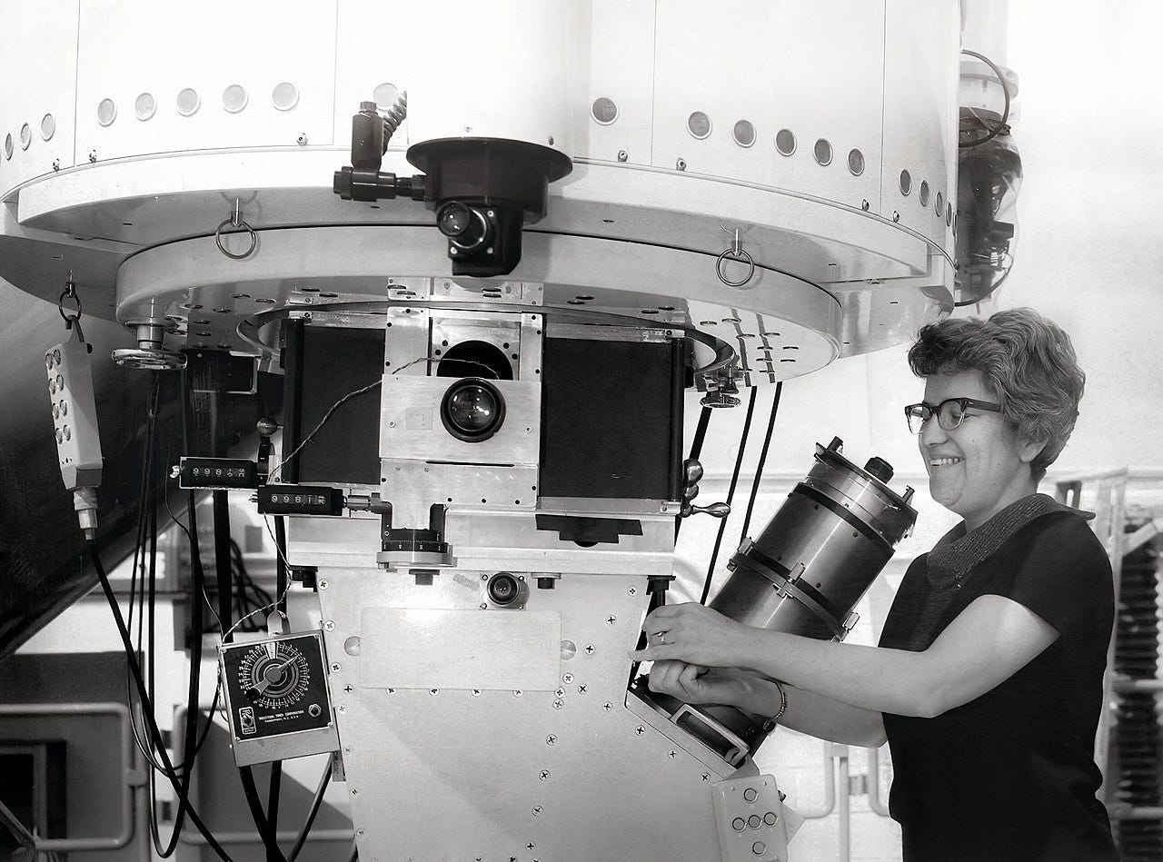 Photo of Rubin adjusting part of a large telescope