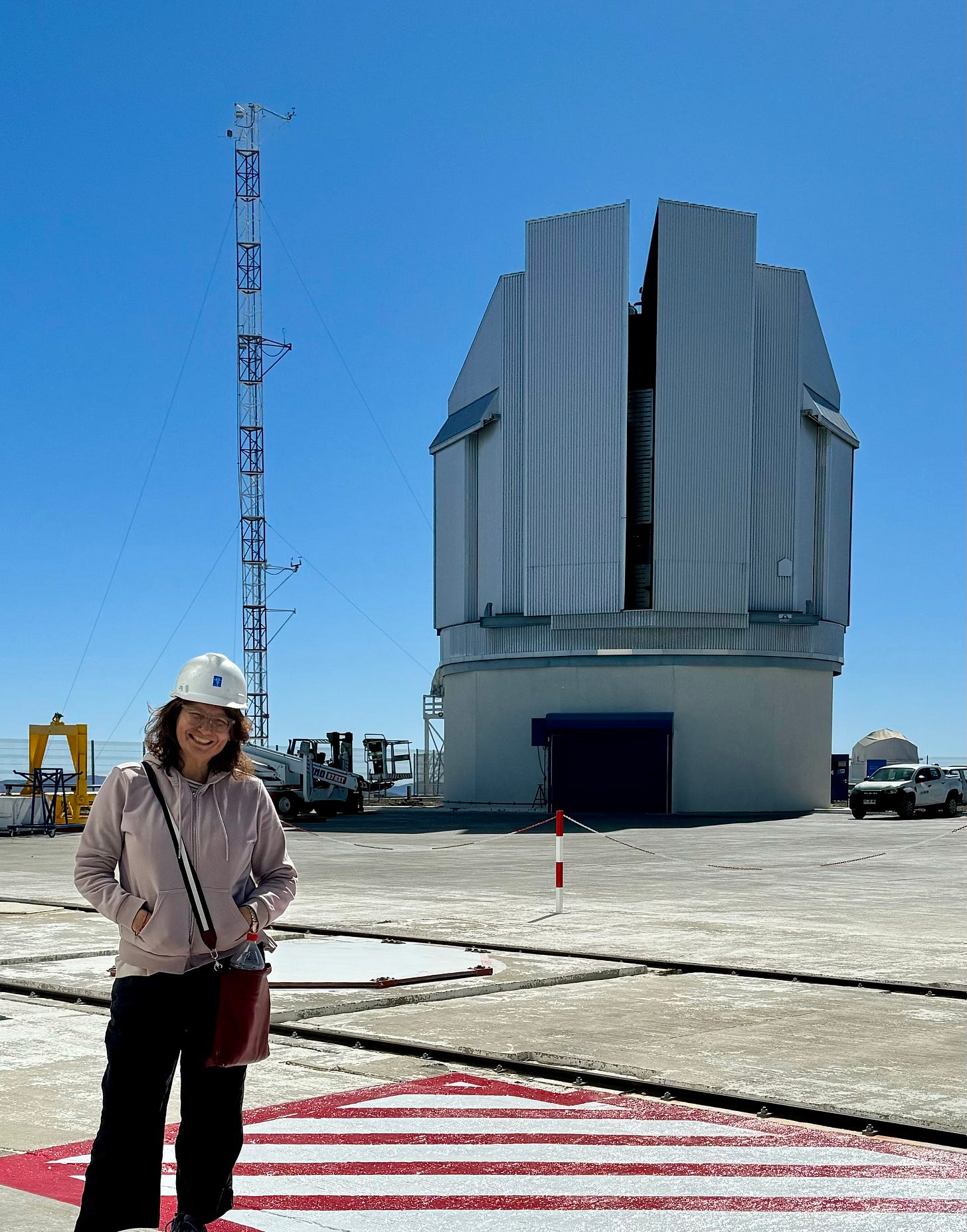 La autora delante de uno de los telescopios mapeadores de Paranal, que está un poquito abierto. Foto archivo propio.