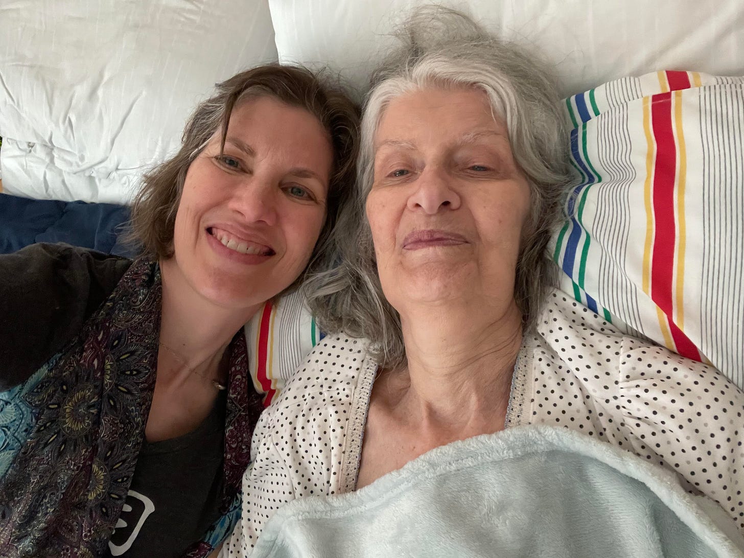 Selfie of Mom, at 81, and me resting on her bed