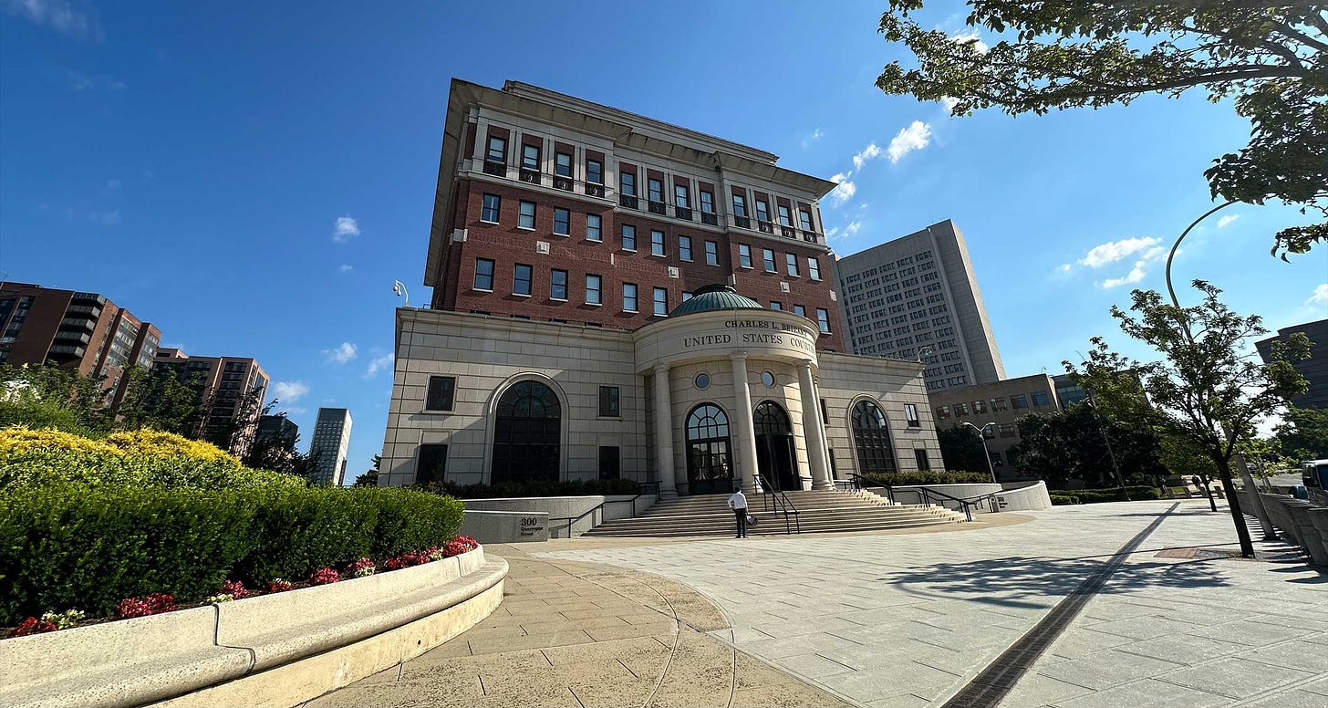 Exterior of federal courthouse on a sunny day in New York.