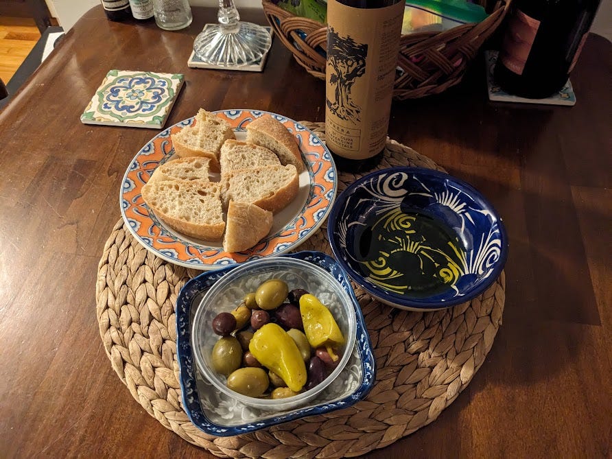snack spread of homemade ciabatta bread, olives and olive oil