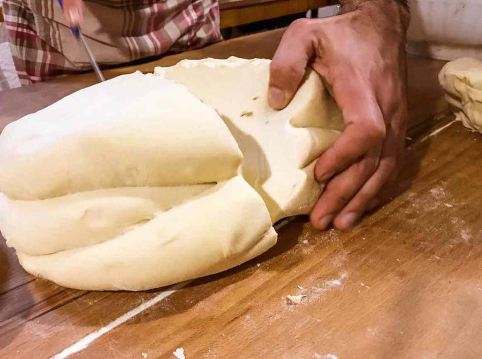 cutting bread dough for kneading