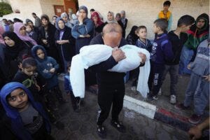A Palestinian mourns a relative killed in the Israeli bombing of the Gaza Strip in Deir al Balah, Gaza Strip, on Sunday, Feb. 11, 2024