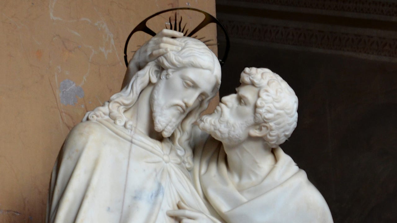 A statue of Judas kissing Jesus on the cheek.