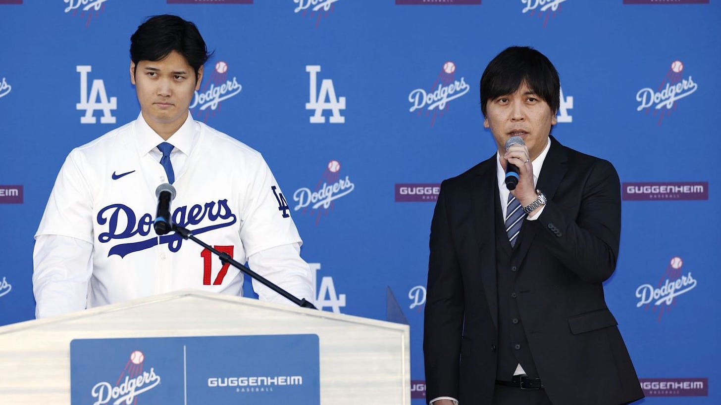 Los Angeles Dodgers player Shohei Ohtani, left, attends an introductory press conference with interpreter Ippei Mizuhara on December 14 at Dodger Stadium in Los Angeles.