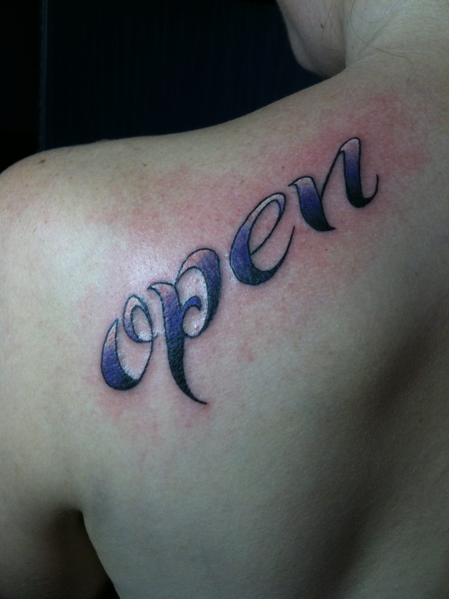 fresh tattoo on back that says "open"