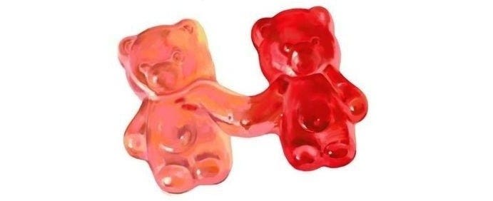 This may contain: two gummy bears sitting next to each other on a white background with the same color