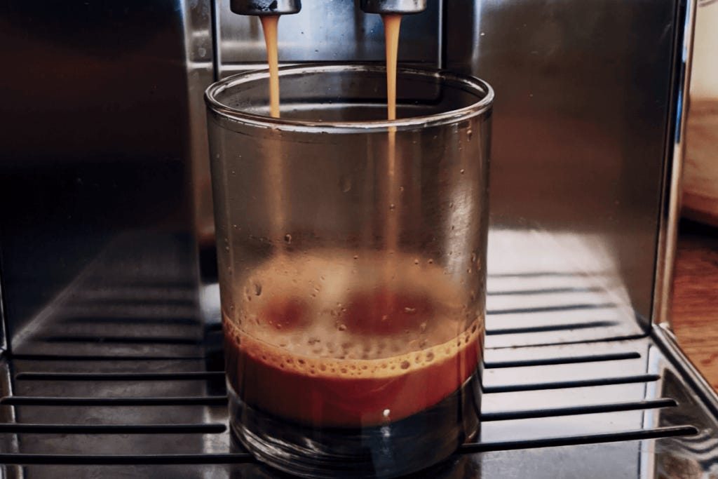 Espresso brewing into a cup.