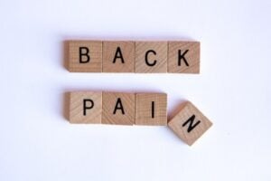 BACK PAIN spelled out in Scrabble tiles