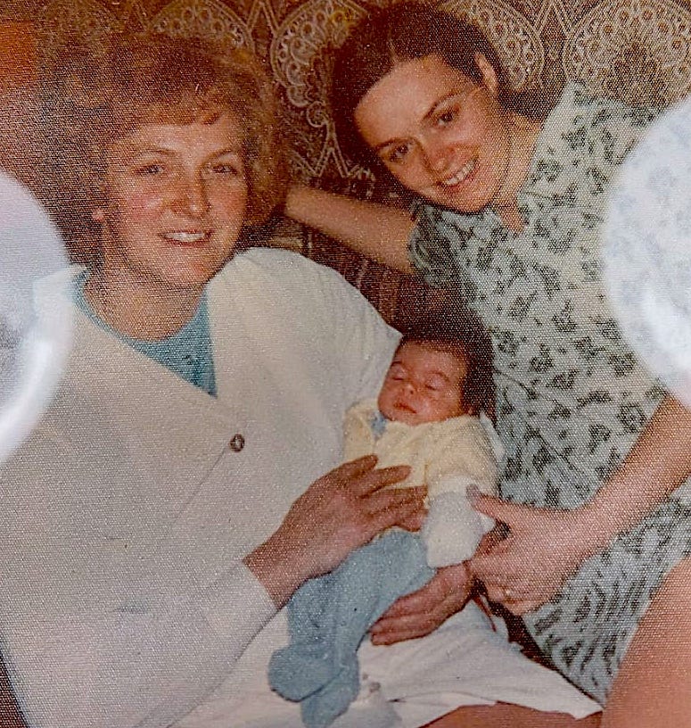 middle aged woman, young woman & baby in 1970s outfits