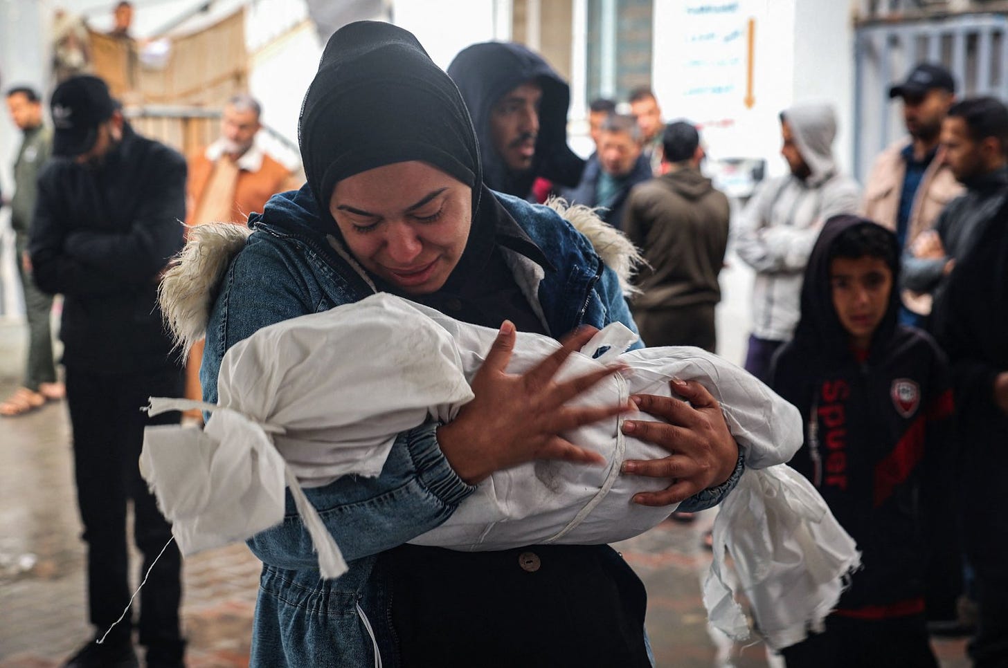 A woman mourns as she carries the shrouded body of a child killed by overnight Israeli strikes on Rafah in the southern Gaza Strip, Palestine, May 6, 2024. (AFP Photo)