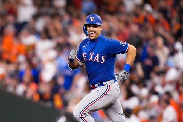 Nathaniel Lowe of the Texas Rangers celebrates while rounding the bases after hitting a two run home run against Bryan Abreu of the Houston Astros...