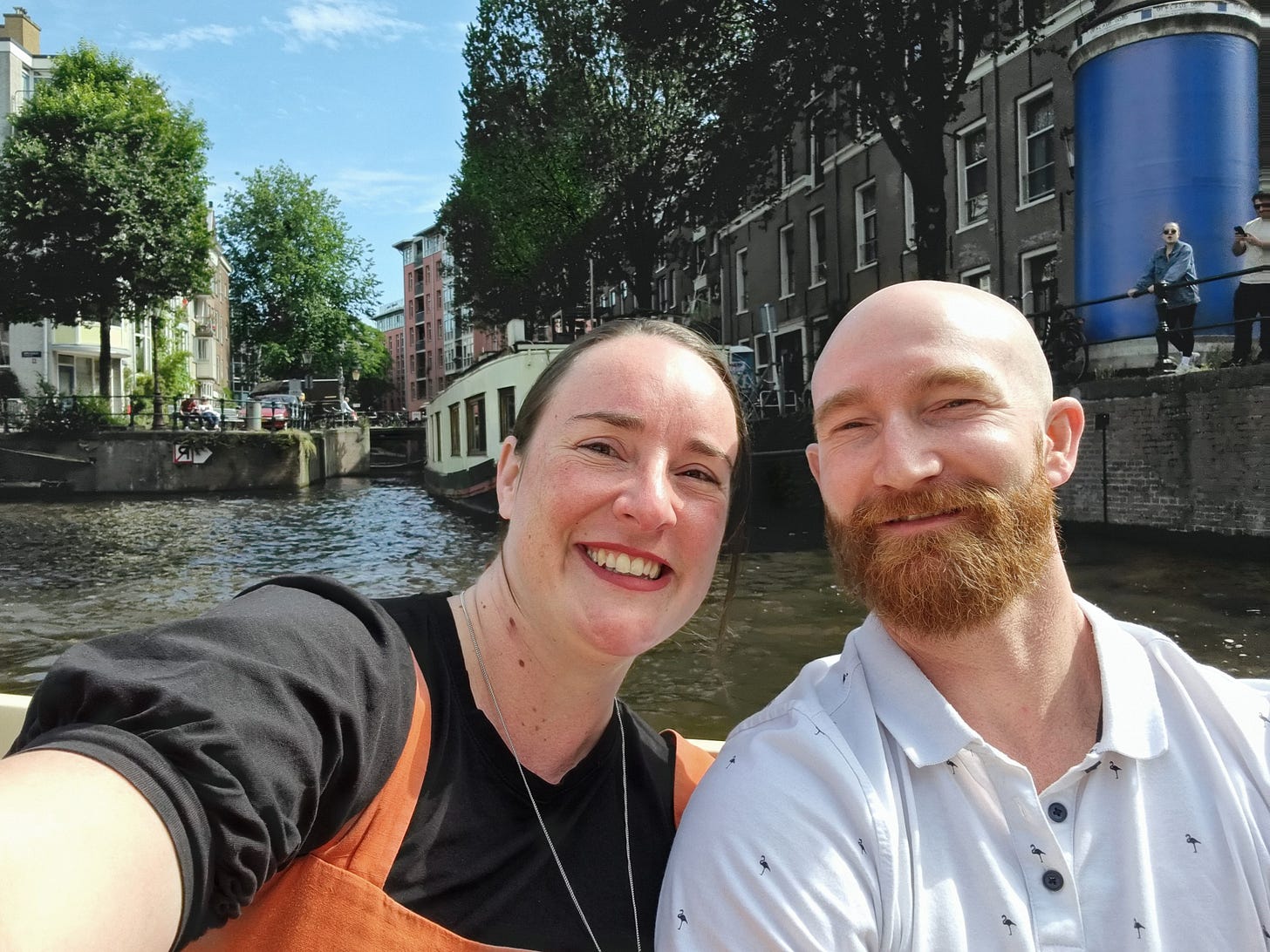 Selfie photo of Aisling and Dave on a boat with a canal in the background.