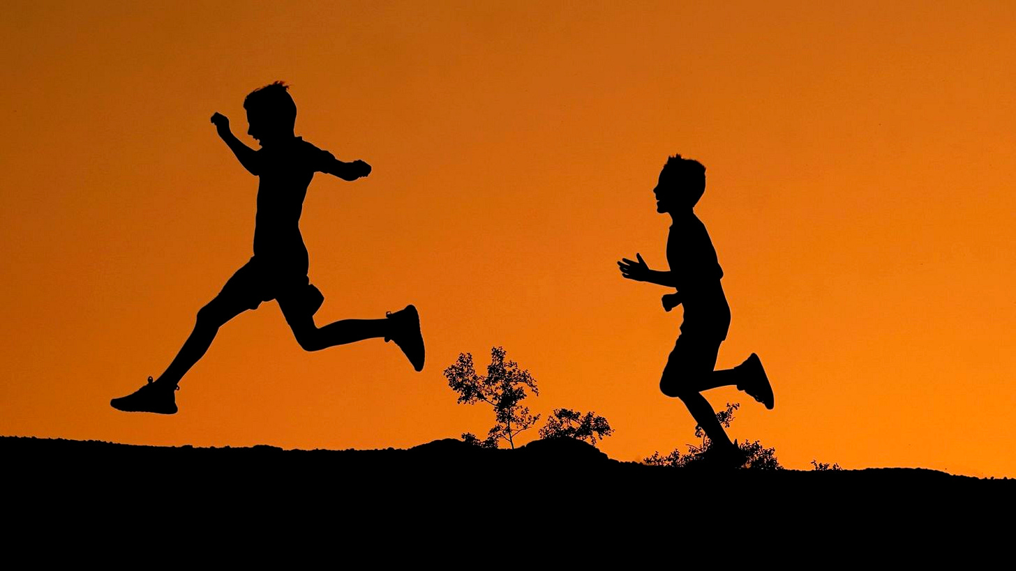 Boys run along a ridge at Papago Park in Phoenix. Boys run along a ridge at Papago Park in Phoenix.