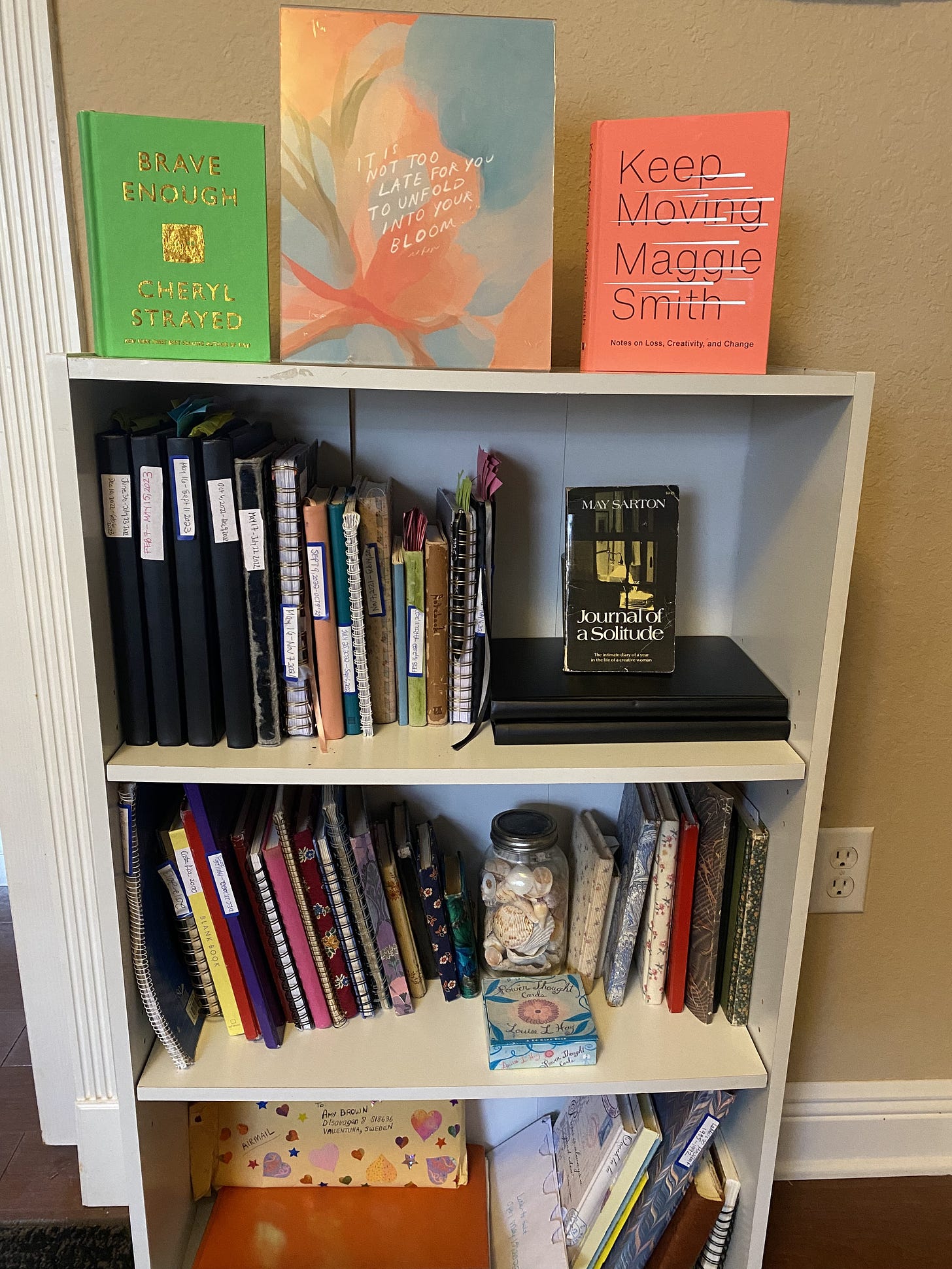 bookshelf with journals, Maggie Smith's Keep Moving, and other books
