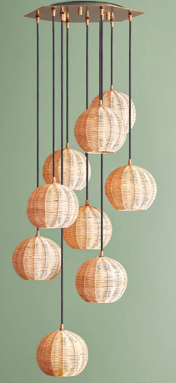 Selection of individual rattan shades in varying lengths as part of a chandelier