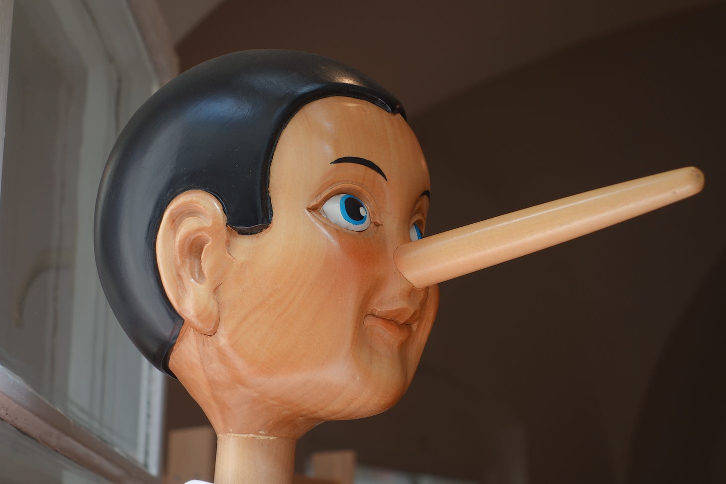 A photo of a wooden pinocchio doll.