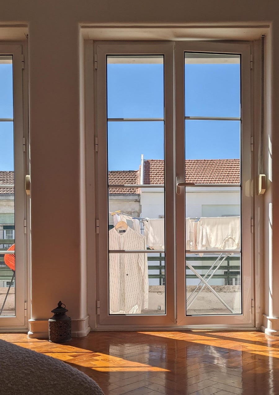 photo of a window looking out to laundry drying in the sunshine