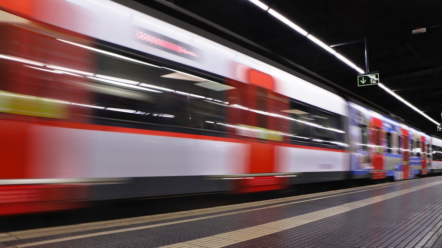 A subway train rolls into a station in Barcelona.