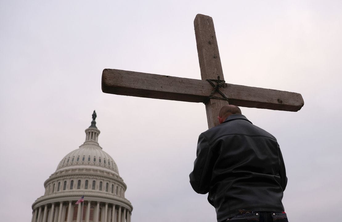 WASHINGTON, DC - JANUARY 06: Supporters of U.S. President Donald Trump pray outside the U.S. Capitol January 06, 2021 in Washington, DC. Congress will hold a joint session today to ratify President-elect Joe Biden's 306-232 Electoral College win over President Donald Trump. A group of Republican senators have said they will reject the Electoral College votes of several states unless Congress appoints a commission to audit the election results. (Photo by Win McNamee/Getty Images)