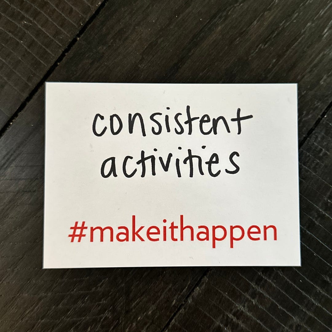 a photo of a sticky note that has, “consistent activities” written on it and includes #makeithappen preprinted on the bottom